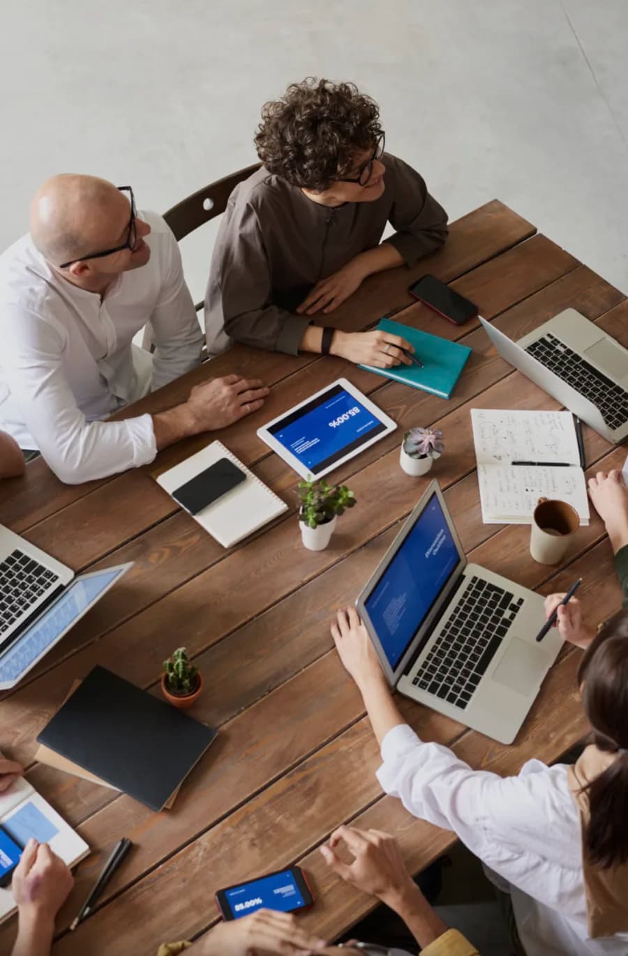 Equipo de trabajo reunido alrededor de una mesa, vista cenital